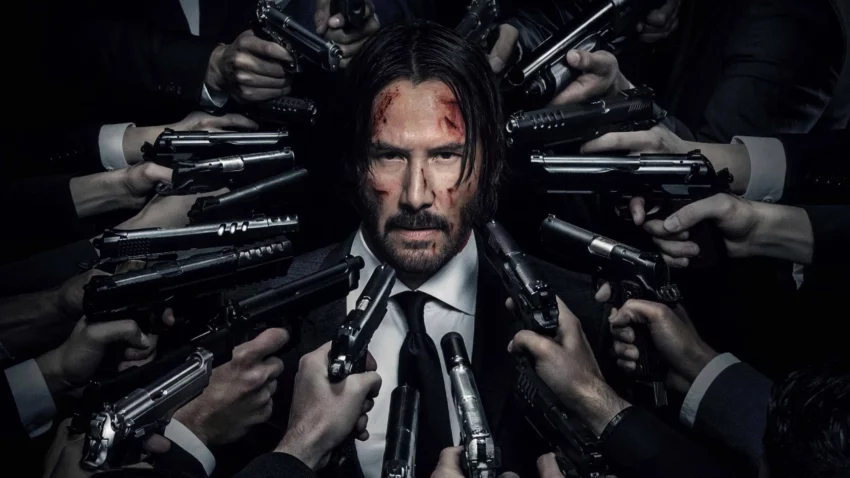 Bannière du film John Wick 2 avec Keanu Reeves encerclé par des flingues.
